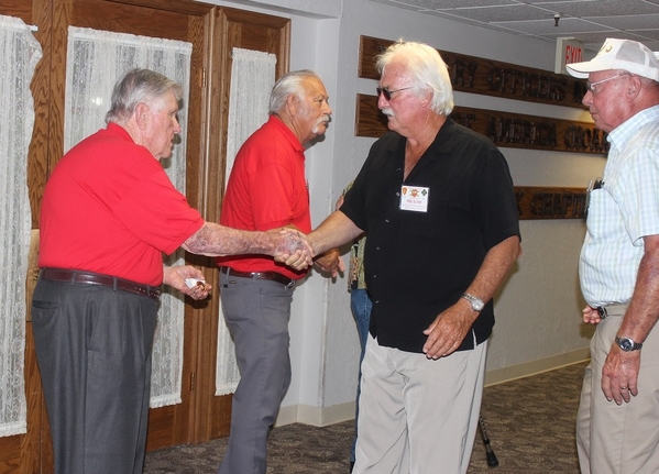 The Waldman Collection - Presenting Gifts
Host Jerry Orr shakes hands with J. Fred Oliver, one of our FOs, and presents a "challenge coin". "Cowboy" Danny Fort in the background. 
