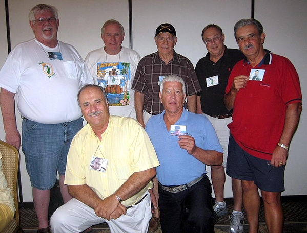 "Who Am I?"
Perhaps it should be "Who Was I?" as the 2/9th FOs hold up photos of the "Nam Days".  L to R: Gary Dean Springer, Gene Schmidt, Don Keith, Bert Landau, Mike Kurtgis, Ed Thomas, and Dennis Dauphin.
