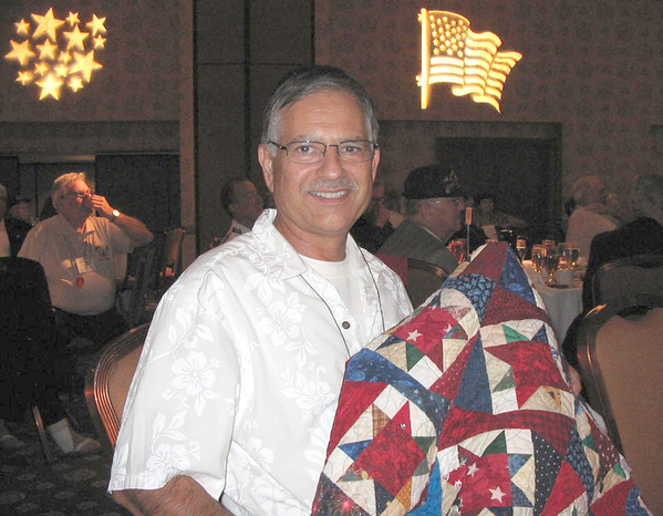 The Banquet
AND THE WINNER IS......Tom Roman!  Tom is pictured here with the quilt he won as a door prize at the Reunion finale event: the banquet.  It was created by the Avila family; they won the 50/50 prize of $550.00!
