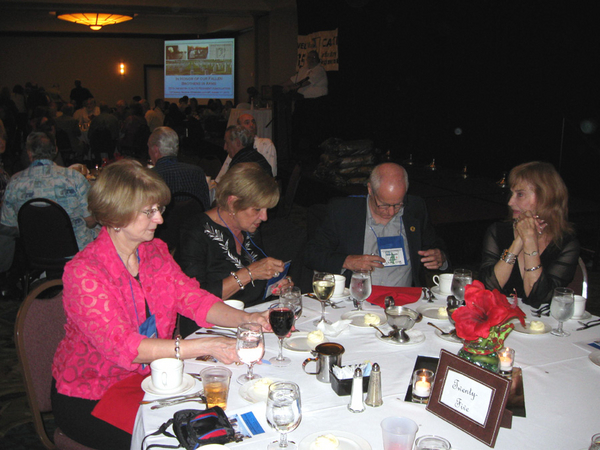 "What's my name again?"
Don Keith seems to be verifying the information on his name tag.  Seated at left is Jackie Dauphin and Barb Keith.  Seated at right is Lorraine Knight.
