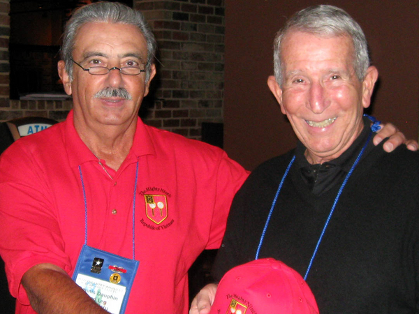 The Presentation
Mighty Ninth Webmaster & Organizer Dennis Dauphin presents Capt Dave Collins, C-1-35, with a "Mighty Ninth" cap in honor of the many years he has invited the 2/9th to attend his unit party at the annual 35th reunion.
