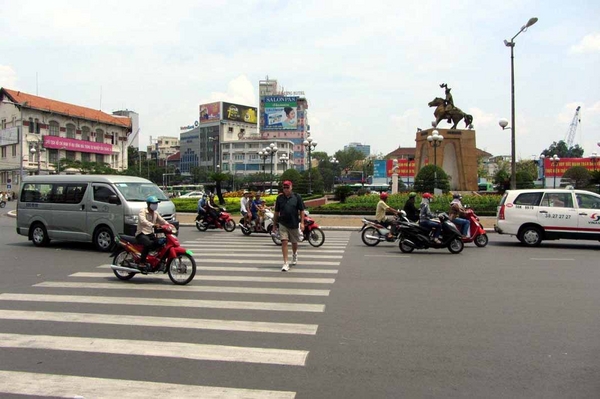 Vietnam: 2012 visit
Crossing the street:  This is the correct way to cross the street in Saigon (now called Ho Chi Minh City).  Look straight ahead and keep moving.  Don't stop or make any sudden movements, and all those vehicles WILL miss you.  It takes a little time to get used to it, and a lot of faith, but it works.  I think the Vietnamese have only one traffic rule:  Try not to run over the tourists.
