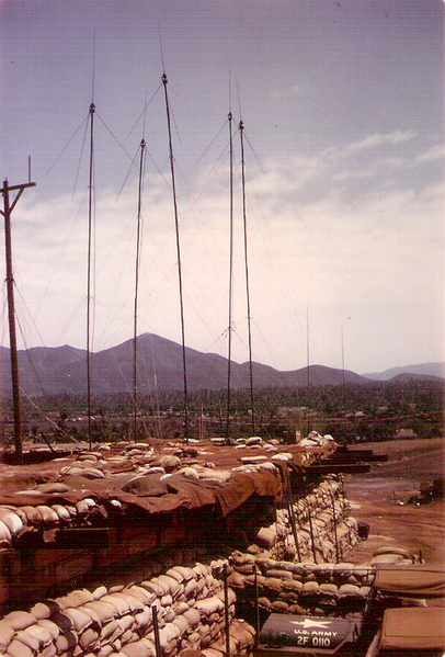 FDC TOC
Spring, 1968.  Next to our bunker was the FDC tactical operations center where we worked.  In the distance, past the Bong Son village, is one of the Tiger Mountains which was festering with VC, unlike the NVA we had seen far to the north.
