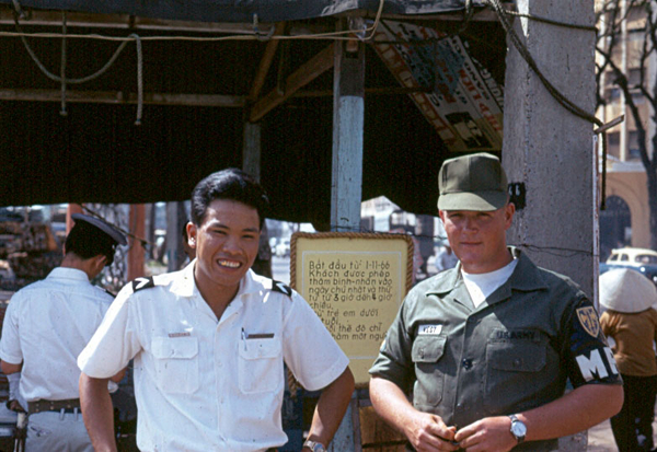 Streets of Saigon
Port Policeman Le Van Cho on the left; Sp4 Jerry West on the right.  Sp4 West was my "tour guide" in Saigon.  Col Robert Sabolyk, the Provost Marshal of Saigon, arranged my one-day tour of Saigon before going out into the "field" with the 2/9th.  I had a one week reprieve.  Never saw Saigon again!

