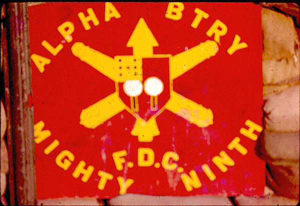 Signage
The unit crest imposed on the Artillery branch insignia.   "F.D.C" = Fire Direction Center.  Housed and protected in a sandbagged CONEX container.
