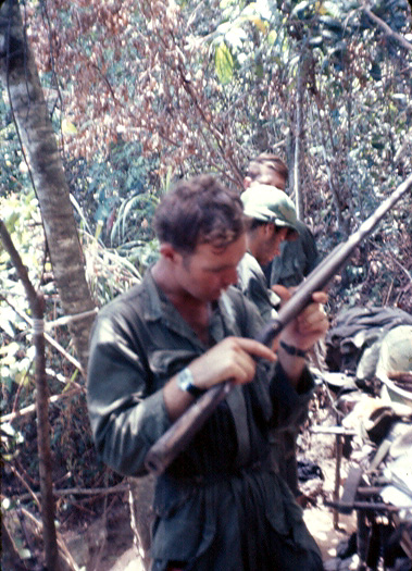 Guy Sherrone takes a closer look at a captured shotgun, courtesy of his FO Don Keith pulling it out of a hole.  It was the very last time that he took on the role of "tunnel rat".  The shotgun was part of a booby trap dismantled by Lt Keith.

