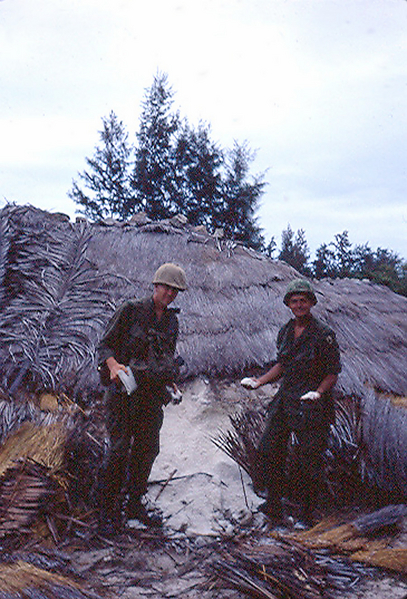 Platoon Leader Lt. John McRae with Capt Ed Nealon (right) holding handfuls of salt.

