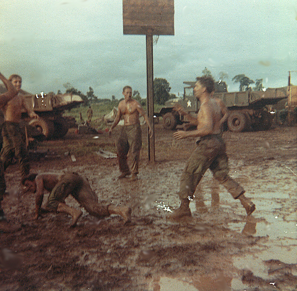 Recess
Monsoon basketball?  Using a mud pit as a basketball court has interesting results.
January, 2014 update: That's First Sergeant Clifford J. Pullan under the basket and Robert Kornagay on the ground; Geary Burrows is at upper left.
