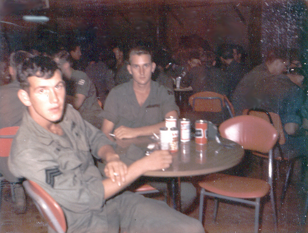 One for the road....the LONG road home
Celebrate!  Downing a few beers at the Pleiku NCO Club just before heading home.  There's still room for a lot more empty beer cans on the table.

