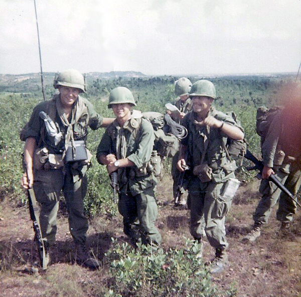 All Smiles
Another day humping the boonies.  At left is the Company RTO, David Cook, center is our medic, and, as usual, all medics are known as "Doc".  His real name is Reinhard Heubaum and he lives in Chicago.  That's me me with the  bandana around my neck (OD in color, of course).
