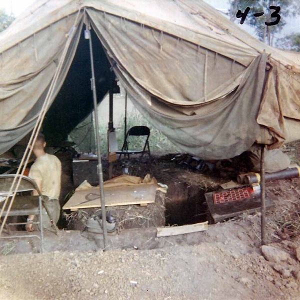 FDC Tent - Field Version - May 1966
After the "Pink Kitty", after the GP-small above-ground tent, after the submerged CONEX containers, this is what my FDC looked like out in the "boonies".    Our FDC was arranged in a horseshoe trench; we could maneuver around the firing charts.  The Operation was "Paul Revere"; the location is south of Duc Co".  
