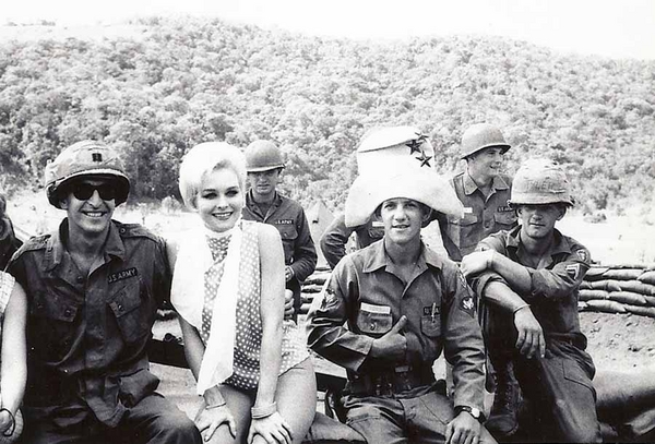 Field Entertainment
Sgt Cook does a "Napoleon" pose seated next to an unknown star in the entertainment world. But, thanks to Danny Yates, he now knows that it is Diane McBain sitting next to him.  She is wearing the same outfit she wore while visiting Danny Yates' battery.  The arm of Tippi Hedren can be seen next to the Battery Commander.  Seated next to Joe is Cpl William C. Tyler, based on the name placed on his helmet liner.
