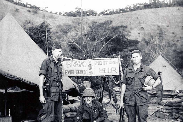 Lt Herrick, 2/9th FA staff; Lt James A. Mager, Corps of Engineers
Joe poses with two Lieutenants.  The sign overhead reads: "Bravo Ever Ready" and "Mighty Ninth Sir" with the unit designation and the 25th Inf Div Tropic Lightning patch in the center.

L to R: Lt Chris Q. Herrick and Lt James A. Meger (Corps of Engineers) on either side of Sgt Joe Cook.

