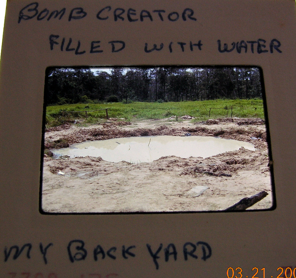 Bomb crater
According to the cardboard mount, it indicates a bomb crater filled with water.  I think it was a 500-lb bomb.
