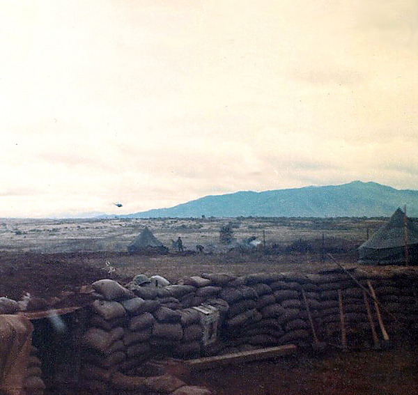 Base Camp - Christmas, 1966
Another typical day in Nam; Huey arrives in lower left center into the firebase.
