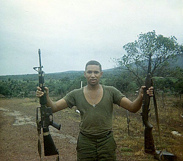 LZ English - Bong Son
Me and some of the guys in commo managed to "acquire" a few unauthorized, non-standard arms. Along the way I had a "grease-gun", a "B.A.R.", a captured AK-47, and others. I also carried an M-16 "over and under" (grenade launcher underneath the barrel) until they took it away! Here I am at English with one of my "slightly modified" early M-16s (note that the prongs on the barrel end are NOT joined) and an M-1 A-1 rifle I loved. I also carried a .45 sidearm given to me by one of the officers. And would you believe that I am NOT a "gun guy"?

