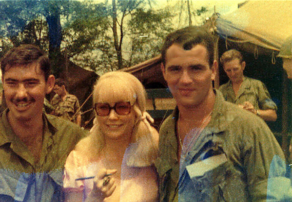 The Blonde Bombshell
Cpl Jim "Tex" Shelton and PFC Rick Ericksen seemed to enjoy escorting this radio and TV personality actress Chris Noel around the firebase.  Well...at least it beats KP.

December, 2014, Capt Stu Royle adds some interesting additional info:
I know no one is looking at it, but immediately behind the 3 is the 1/14th Infantry VIP briefing tent and  it had some captured VC/NVA weapons and equipment on display. I found a 8mm film that I took of Chris getting off the helicopter and being escorted to the 1/14th by LTC Robertson, 1/14th CO but can't get digital images from the film that are viewable.

