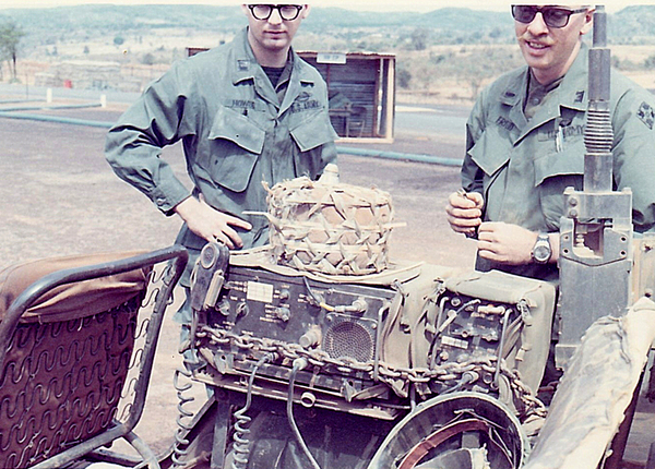 Studying the mines
A pair of 4th Inf Div engineer officers, Lt Howze and Lt Friend (sp) study a mine sitting atop the jeep radio.
