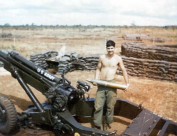 Faux Cannoneer
Date: 30Dec68  Location: LZ Schuyler

I don't really work on the guns, but it made for a good picture.   Note the new M102; goodbye M1A101 & the "trails".

