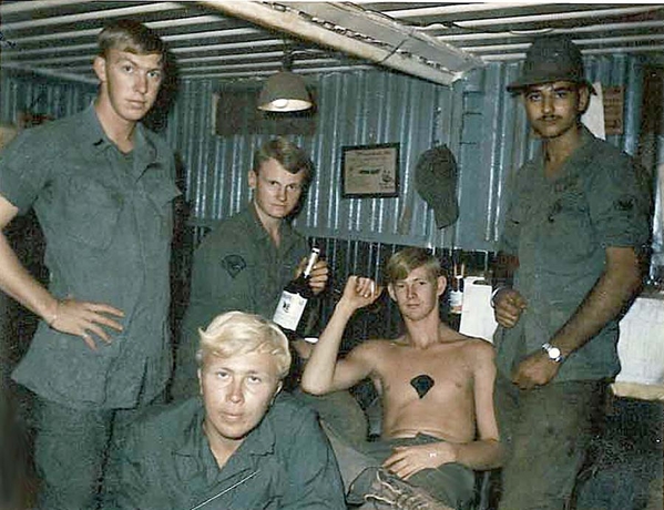 LZ Ranger II
The "gang" gets ready to kill a fifth of something.  At left, standing,  is Lt Don Blankin; Sp5 Jay Flamme next to him.  I'm wearing the fancy hat.
