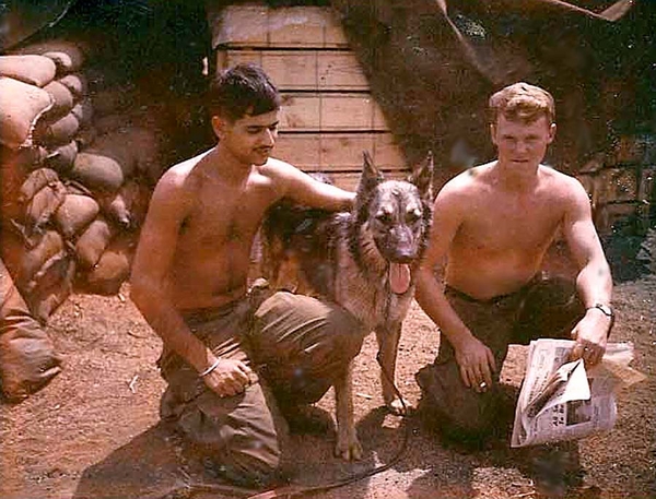 Donut Doggie
Date: 20 March  Location: LZ Valentine.
Jay Flamme & I with a scout dog at LZ Valentine.  Post Note: I learned that Jay was killed in an accidental shooting on the range after returning from RVN, 1969.
