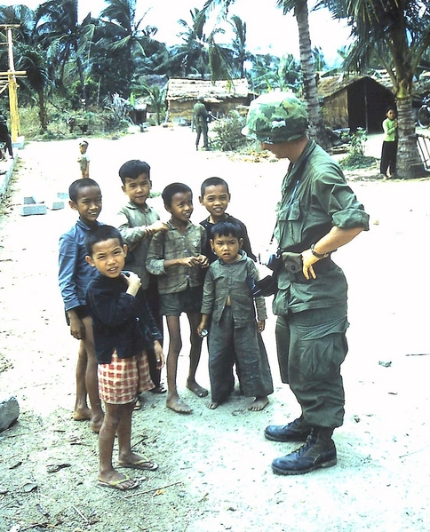 Soldiers and Kids
An Infantryman of B-1-35 meets with Vietnamese children in a village.  Our troops routinely gave kids candy and goodies from the C-Ration supplies.

According to the US news media, these men were labeled as "baby-killers".  The news media got it wrong, as usual.  It was the VC who entered the villages and killed the Village Chief to install their control.
