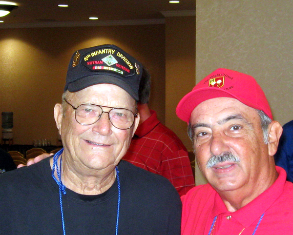 CONNECTED!!
Participating in the Saturday morning business meeting was: (left) 1SG Jack Farmer, attending his first reunion and Dennis Dauphin, creator and Webmaster of "The Mighty Ninth" website.  Jack saw my redleg hat and shirt and asked, "Did you know our FO, Lt Carlton Epps?"

Answer: You BET I do!  Lt Epps was one of the more recently located redlegs of the 2/9th.

