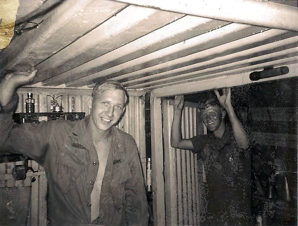FDO and the XO
"A" Battery officers Lt Jerry R. Benton (FDO) and Lt McHugh (XO) touching the roof of the twin CONEX containers of the portable FDC.  Note the trusty ol' pencil sharpener under Benton's right arm and a flashlight magnetized to the joint in the roof.  Benton was later promoted to Captain.
