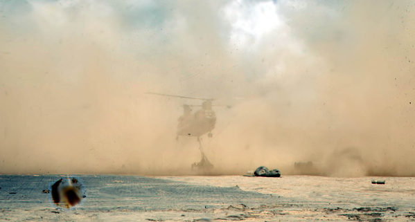 Fantastic shot!
Amazing!  This photo captures, almost magically, the powerful dust storm created by a Chinook when hovering over dry ground and picking up a heavy load, such as one of our 105mm howitzers.  An almost depleted blivet can be seen just outside the huge dust storm.
