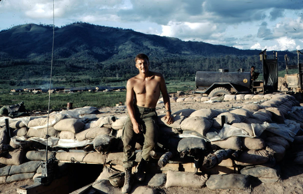 Memories of Nam
Fred sits atop a typical fully-sandbagged bunker with some beautiful scenery in the background.  The all-too-familiar water tank is in the background.  Proper nomenclature is the M-149 Water Buffalo.  The handy-dandy shower stall is next to it.  This firebase looks like a war-time vacation spot.
