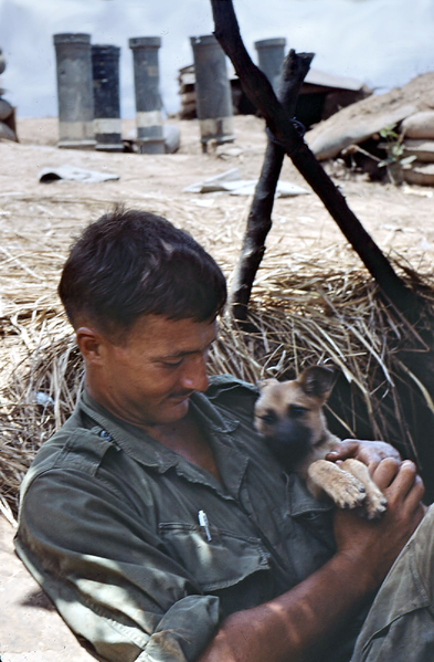Happiness is a warm puppy
This one escaped a Vietnamese cooking pot.  Note that the soldier wears no insignia or rank.
