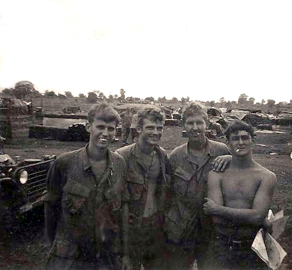 Meanwhile, back at St George
Returning back to LZ St. George from LZ Cathy photo of the September '69 crew:  Sp4 Denny Mrowzinski, PFC Mike Medley, Sp4 George (Eugene) Jarisch and Sp5 Clint Curry. With our trusty power generator for the radios in the background.  Enlarging the photo, you can see 1st Shirt Mac (McPeek) in the background complaining about something.

