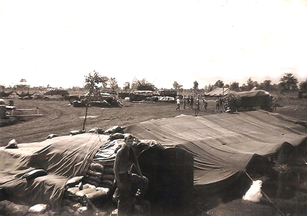 PFC Mrowczynski
Denny Mrowczynski standing at entrance to FDC/1st Sgt hooch at LZ St. George. 
Note volleyball in the background and a mess tent.  We only had it for a short time until one of the cooks burned to death while filling a stove.  {See "TAPS" - PFC Odell Easley}
