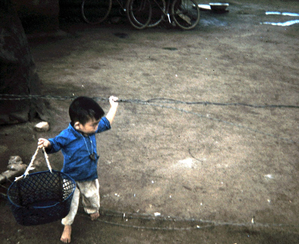 Pleiku series
Small boy playing in the barbed wire.
