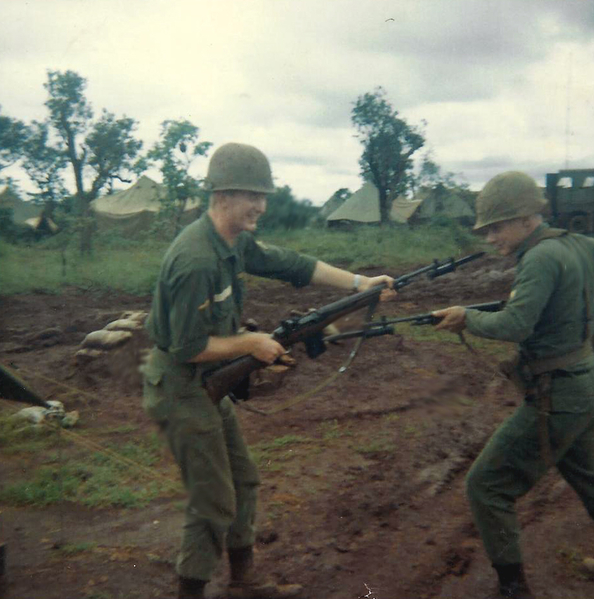 More horseplay
Redlegs Barrington and Wilson engage in a little weaponry horseplay.  Note the stateside OD uniforms.   The 25th Inf Div Advance Party was sent over on Christmas Eve, December, 1965 and the full 3rd Brigade Task Force was deployed in January, 1966.  It took awhile before the jungle fatigues were issued.
