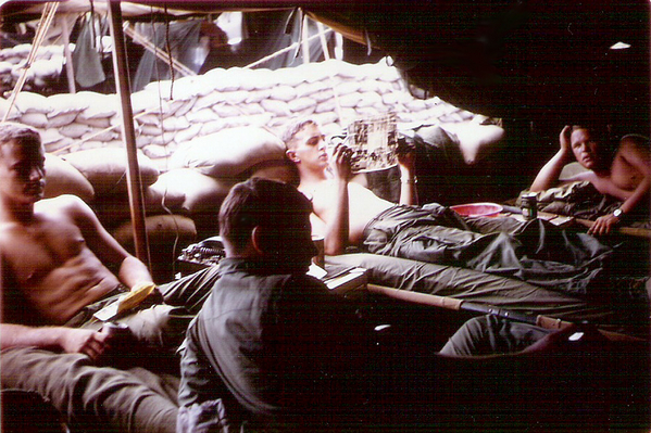 Off duty
Off duty in the tent.  Others on my shift were Glen Bruney and Ronnie Crowe (both leaning against sandbags).  Jim Castelletti (clerk) in the foreground.
