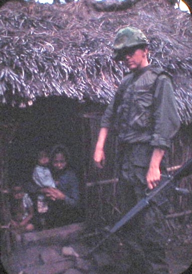 Men of B-1-35
UNK troop stands at hut entrance.  Going thru Vietnamese villages was a very problematic.  Many villagers were glad to see US troops, others very worried when they left and the return of the VC.

Almost every village entered found enemy stockpiles of rice and weapons.  The enemy was hiding behind the peaceful farmers who wanted no part of this war.  The US media never reported this.
