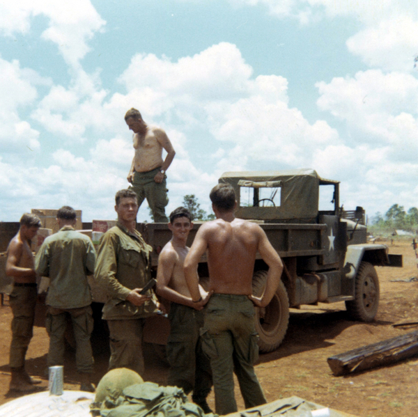 Working at LZ St George
1st Sergeant James E. McPeek unloading for St George, standing in bed of truck.   Facing camera, "Bullet Bob" Burnett, and Clint Curry.
