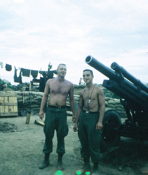Cigar Team
PFC Hourigan puffing away with Sp4 Ronald Hammond, his cannoneer buddy. LZ OD, August, 1967.  
