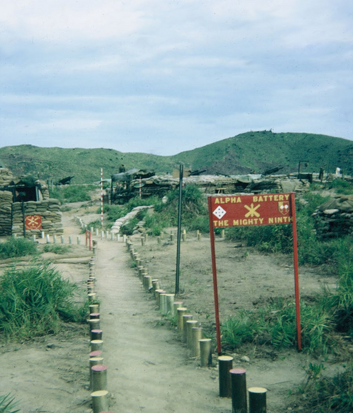 FDC at LZ OD
105mm cannisters lined the path to the sandbagged CONEX that housed the FDC.  The sign in th foreground includes the 4th Inf Div Ivy patch, which indicates the "swap" from the 25th Inf Div had just occurred on 1Aug67.
