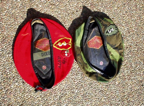 Remember we had berets?
Here are the berets. Note the 2/9th embroidery and the shield on the red one. The other also as "2/9 Arty" embroidered on it, but hard to see. We were told that we were authorized to wear the red only at special functions or on post. And the camouflage was for the field... but our sergeants never made much comment about them and we could not wear them in formations.

