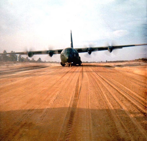 Whatta Takeoff!
Duc Pho Runway, LZ Montezuma, August, 1967.  Although I thought that the runway had metal planking by this time, I could be wrong.  Note the dirt runway with tire tracks. Certainly not a pilot's dream.  Recall taking this shot from the back door of a C-123...a noisy, scary plane, but exciting to fly in especially when they later added JATO-assist pods on the wings.
