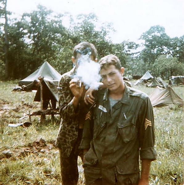 Recon Sergeants
Sgt Walter G. Hyatt (foreground) and Aubrey Dale Ramsey (hiding in smoke cloud) serving as Recon Sgts with an FO team.  Photo taken near Pleiku in 1966.  Ramsey served with the 35th Inf Regiment.  Both Hyatt and Ramsey are deceased. 
