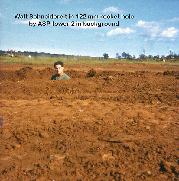 Rocket Hole
Walt stands in the hole made by a 122mm rock near the ASP.   Tower 2 in background.  Now we have lots of fill for sandbags.
