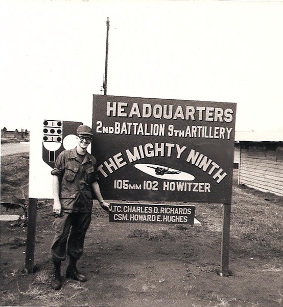 Final Nam Destination
Sp5 James Keller stands next to the Hq, 2/9th Arty sign at Camp Enari before the men are dispersed to other units and The Mighty Ninth returns to the states.

I was at Camp Enari 69/70 HSB, when 2/9th was deactivated was sent to Camp Radcliffe in Mar 70 to 4/42 Arty Btry A.  S3 went home 8Jul70!!
