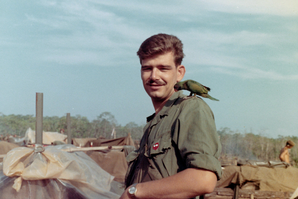 Another Nam buddy
Paul Howe with a parrot on his shoulder. Note the shield of the 2/9th on his left jacket pocket.

